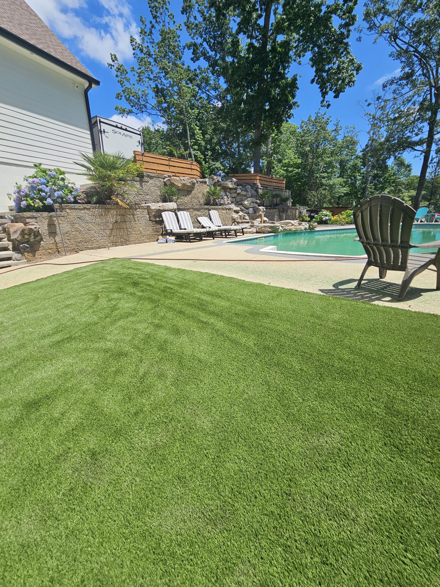 Artificial turf around pool surround installed by Kaizenscapes Canton Georgia