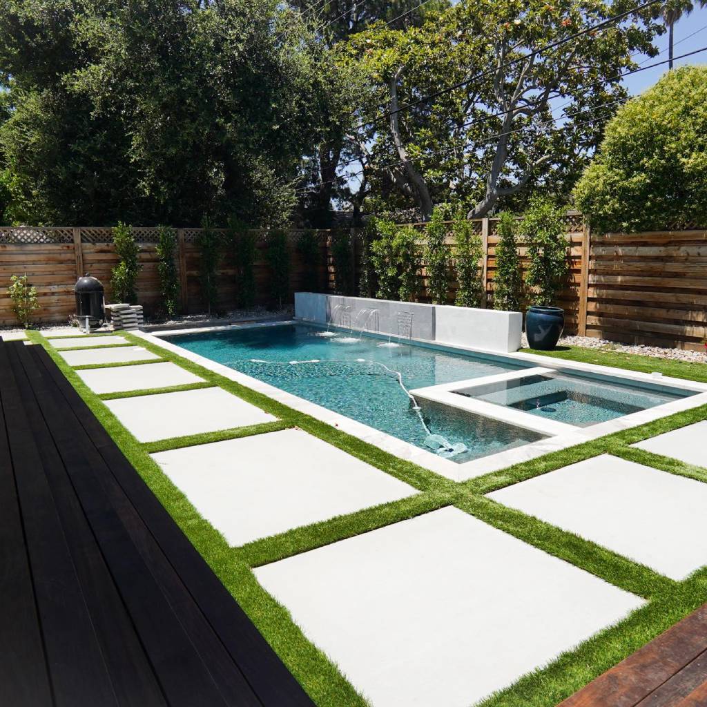 Resort-style pool deck with paver surround in Canton GA by Kaizenscapes