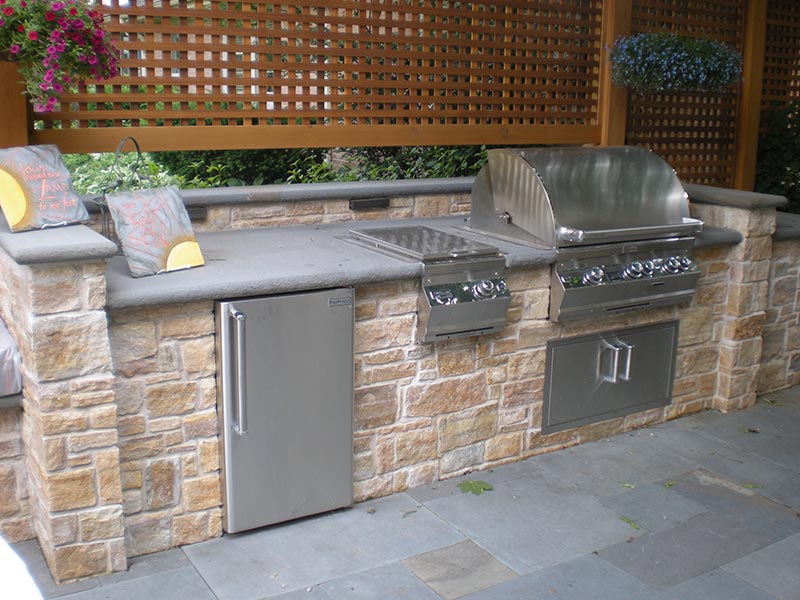 Outdoor BBQ area with granite countertop and integrated grill in Cherokee County Georgia