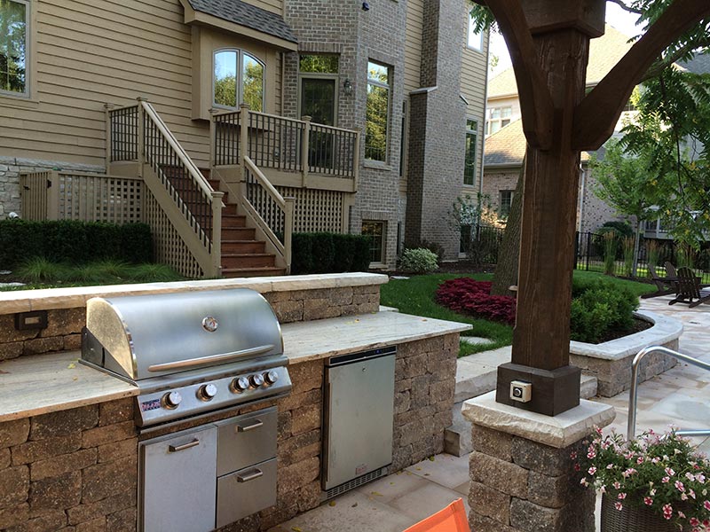Full outdoor kitchen with storage and seating built by Kaizenscapes in Canton GA