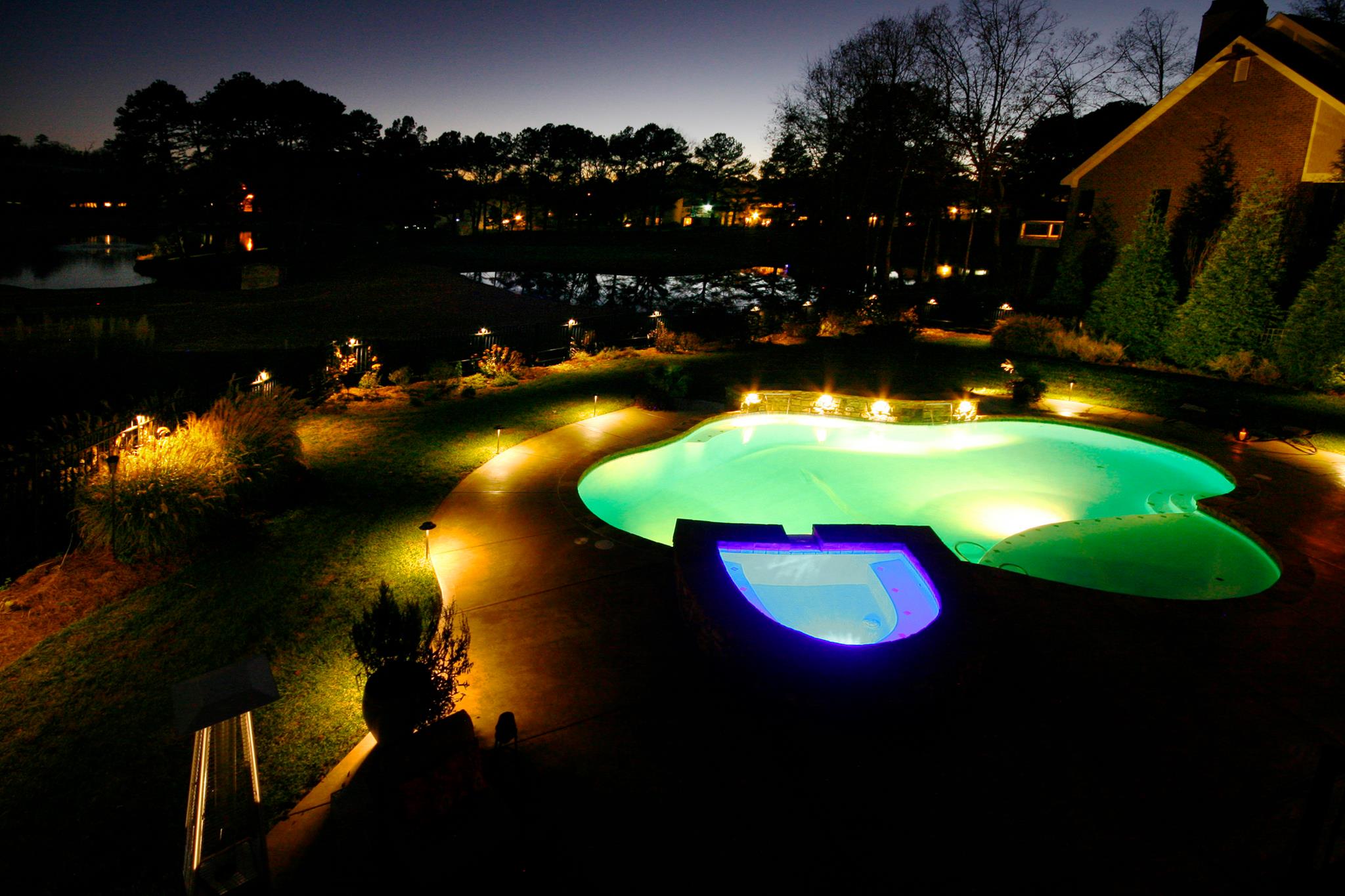 Patio string lighting on pergola structure in Canton Georgia by Kaizenscapes