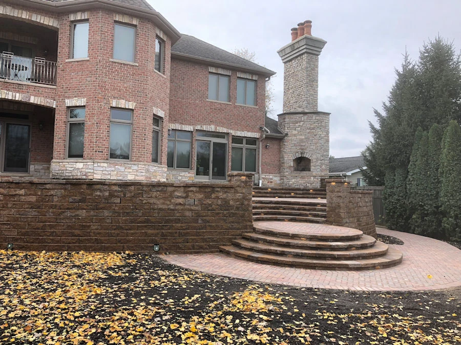 Atlanta-area hardscape installation with stone seat walls and pergola