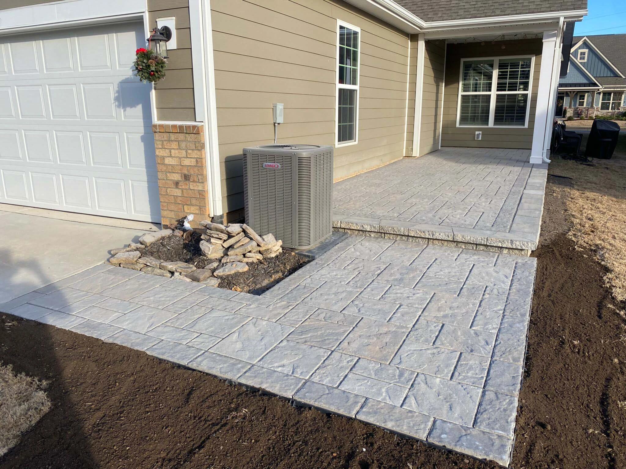 Outdoor patio with stone fireplace and seating in an Alpharetta backyard