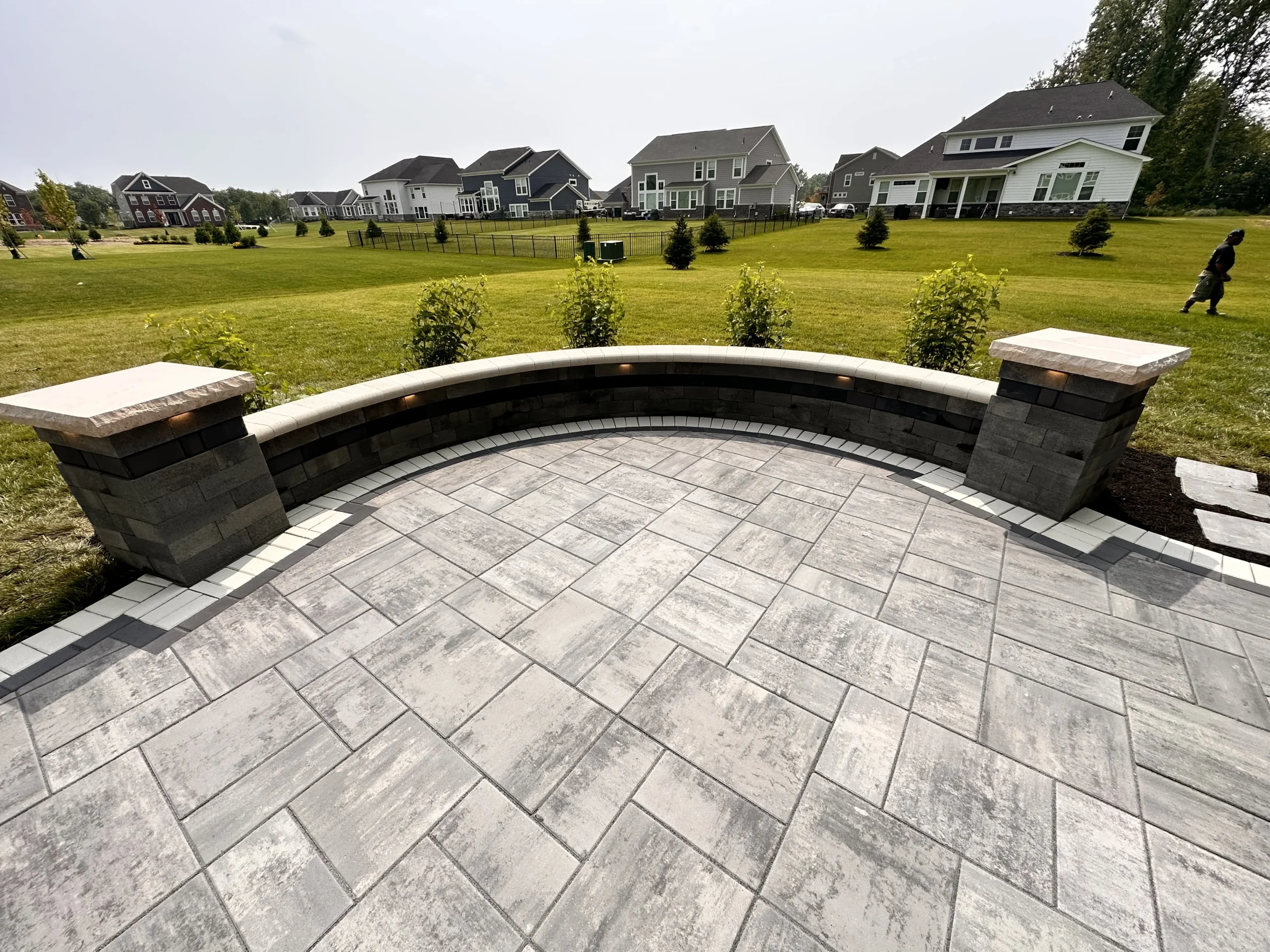 Travertine pool deck with seat walls in Alpharetta GA backyard