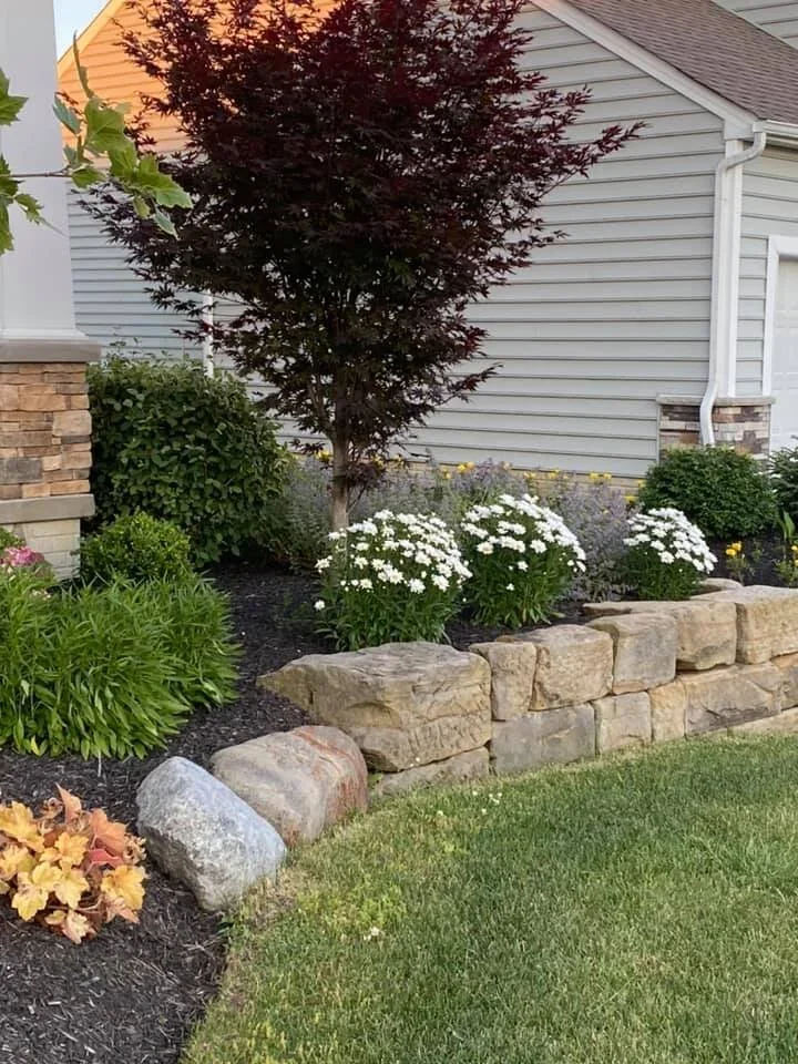Cumming hardscape contractor finishing a paver walkway with stone columns