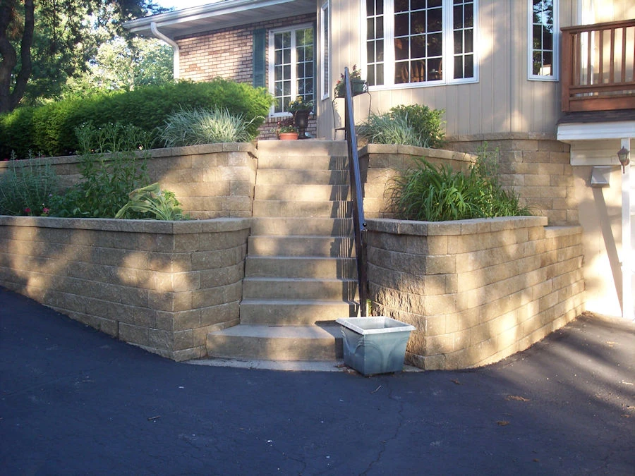 Hardscape installation in a Marietta backyard with mature oaks and a stone seating wall
