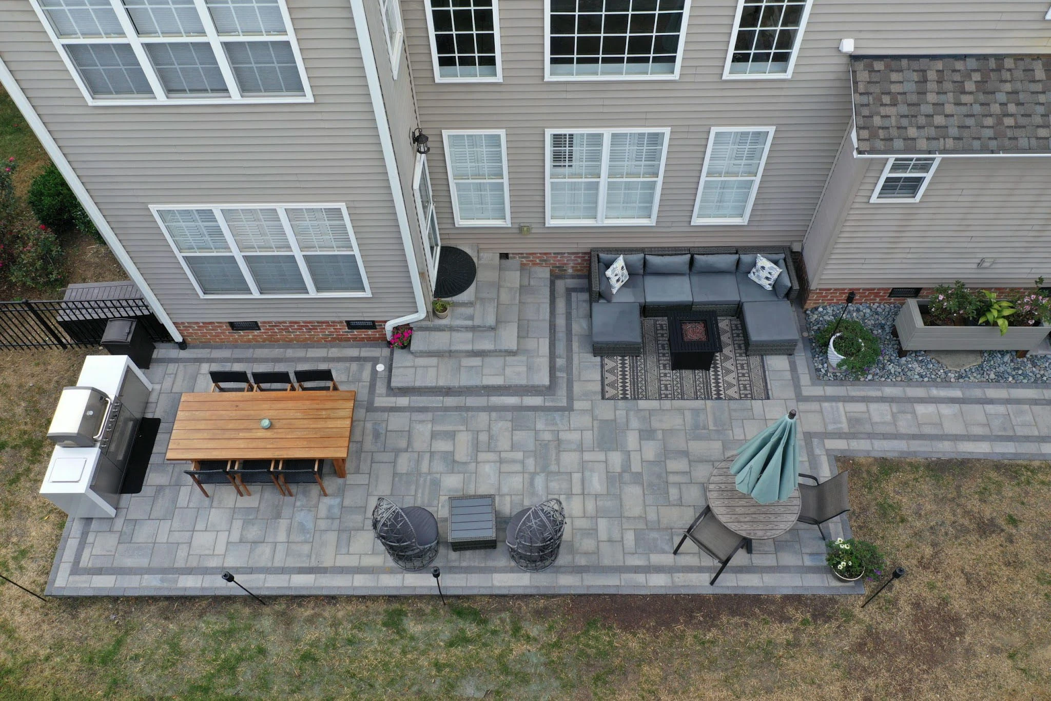 In-progress paver patio installation in a Marietta backyard