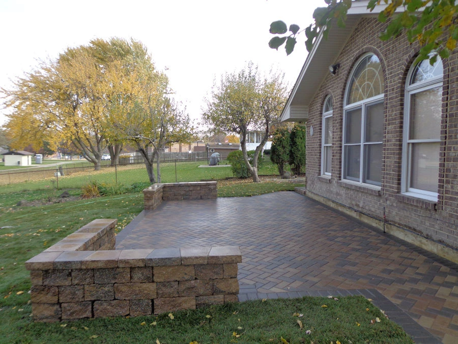 In-progress paver patio installation in a Marietta backyard with crew working