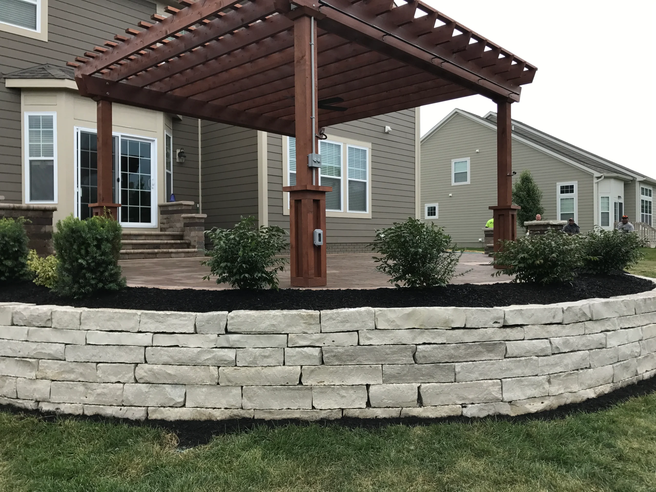 Paver patio with seat wall and fire ring on a Milton GA estate property