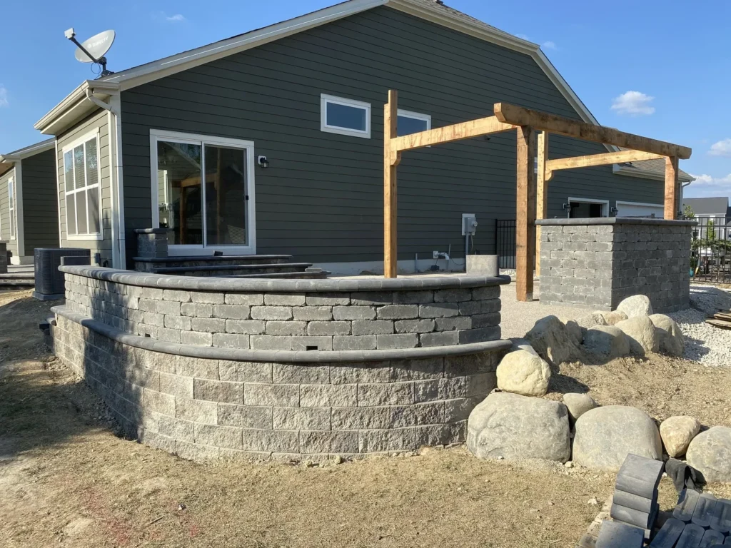 Hardscape patio with built-in seat walls and stone columns - Milton, GA hardscaping contractor | Viral Spark Marketing
