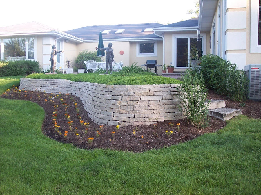 Natural stone retaining wall and traditional planting in a Roswell GA backyard near Litchfield