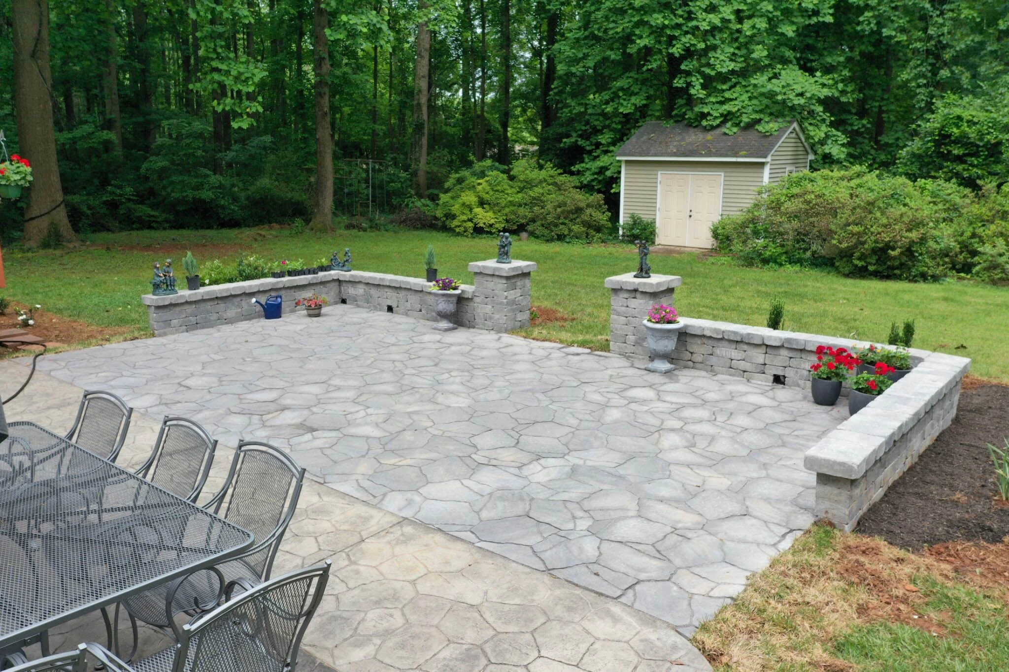 Aerial drone view of paver patio installation with mature landscaping in Roswell