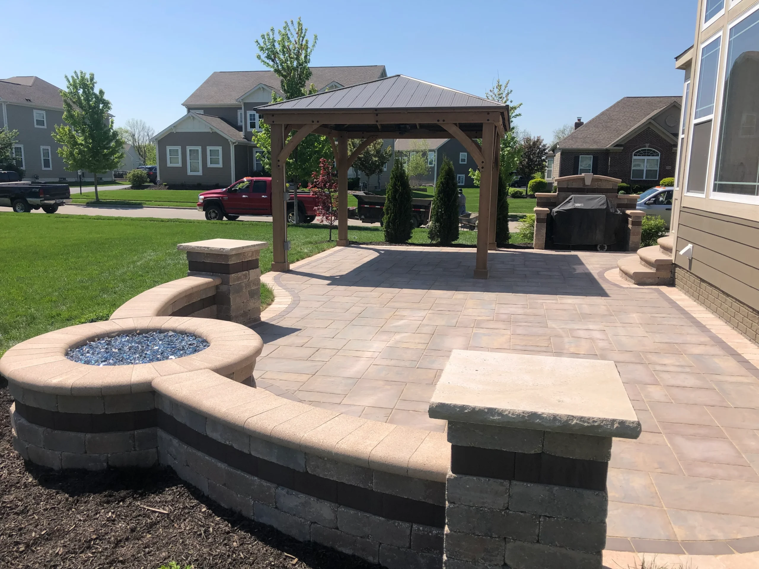 Twilight outdoor living space with paver patio and pergola in Roswell