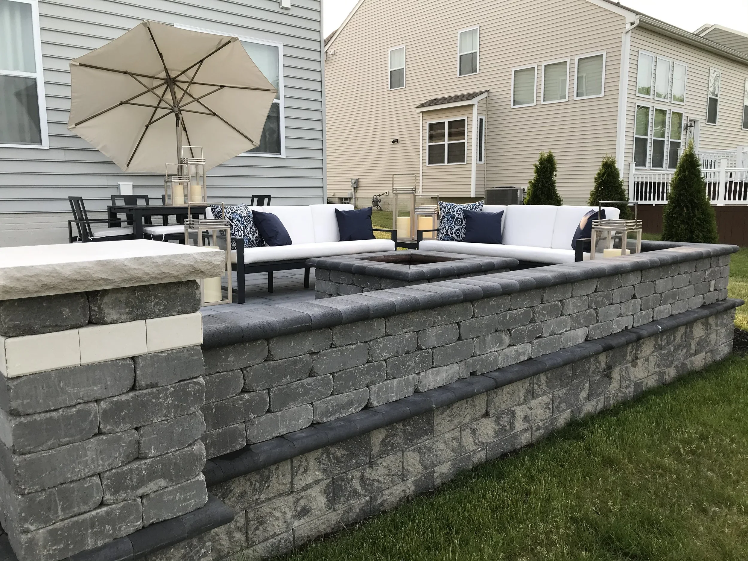 Outdoor living space with retaining wall and landscape lighting in Smyrna GA
