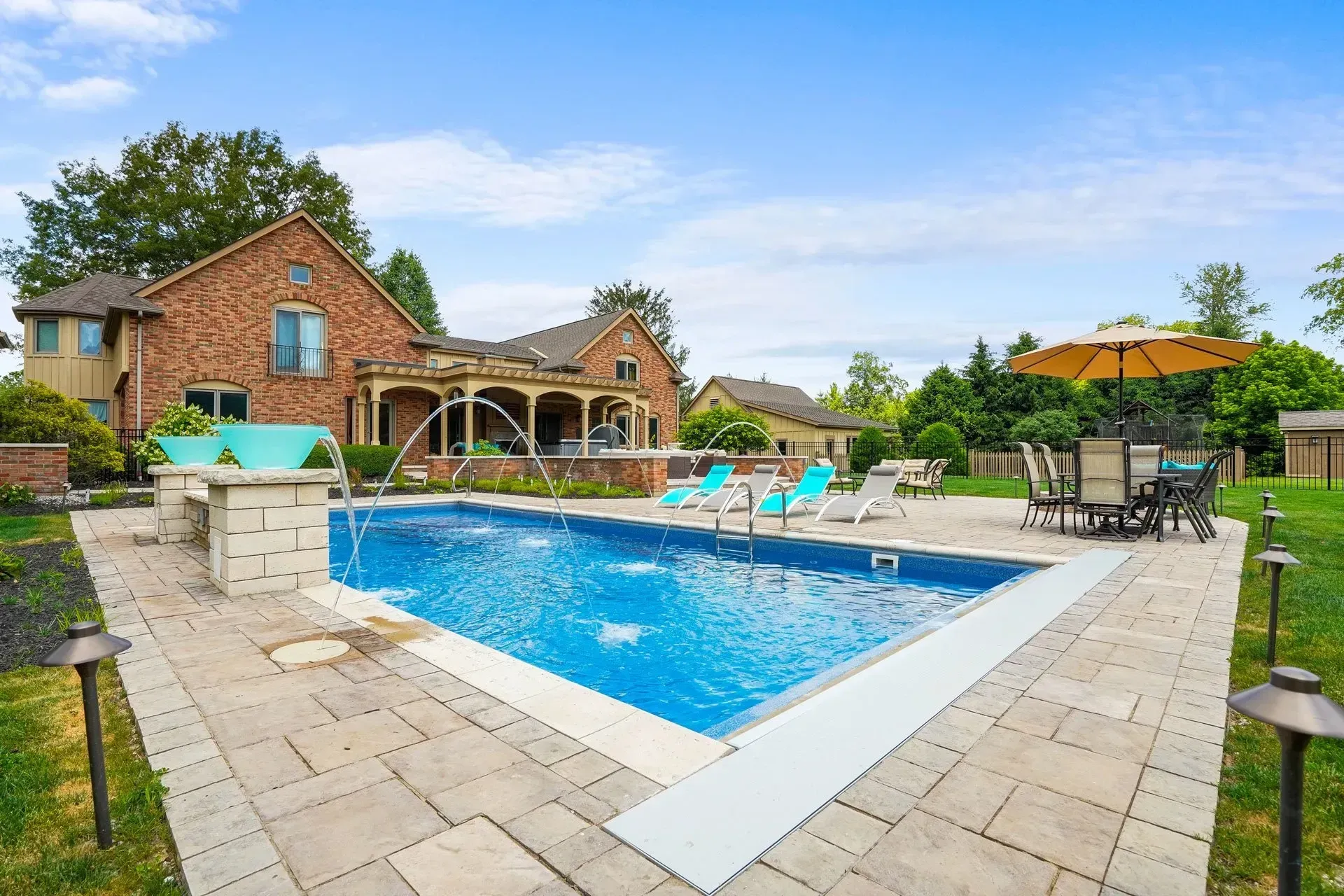 Finished Cumming pool build with travertine deck — example of owned-funnel content asset