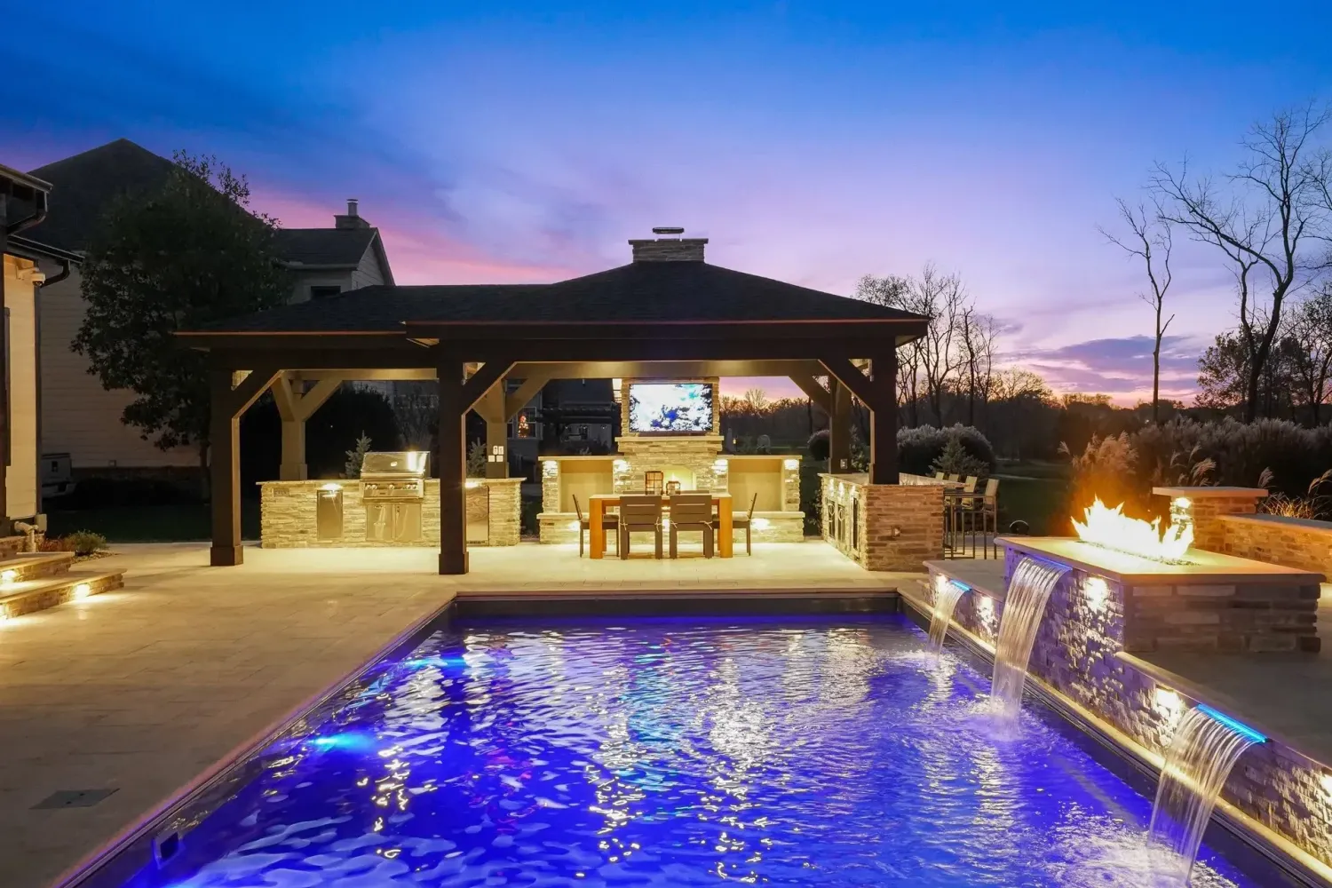Sunset pool with outdoor kitchen and pergola in Duluth GA