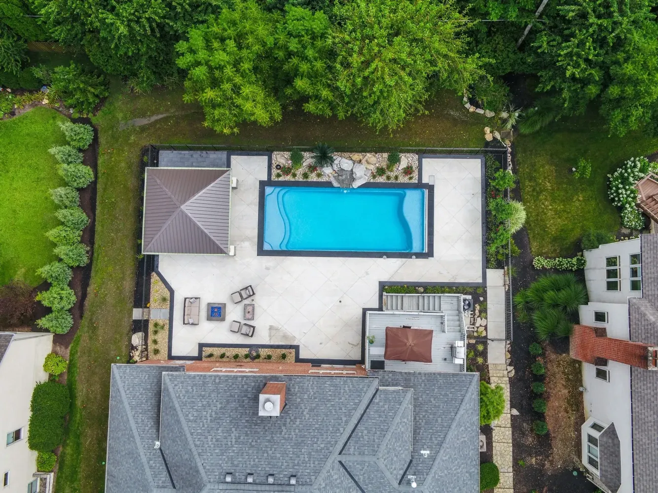 Johns Creek pool build with paver deck and seat wall