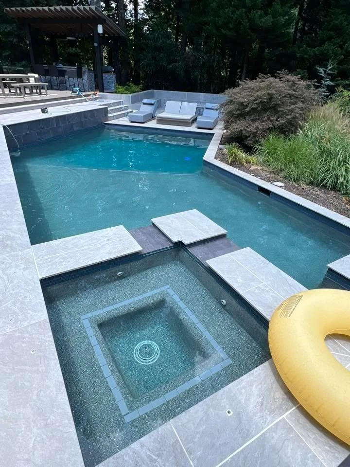 Luxury Johns Creek pool with paver deck and outdoor living area