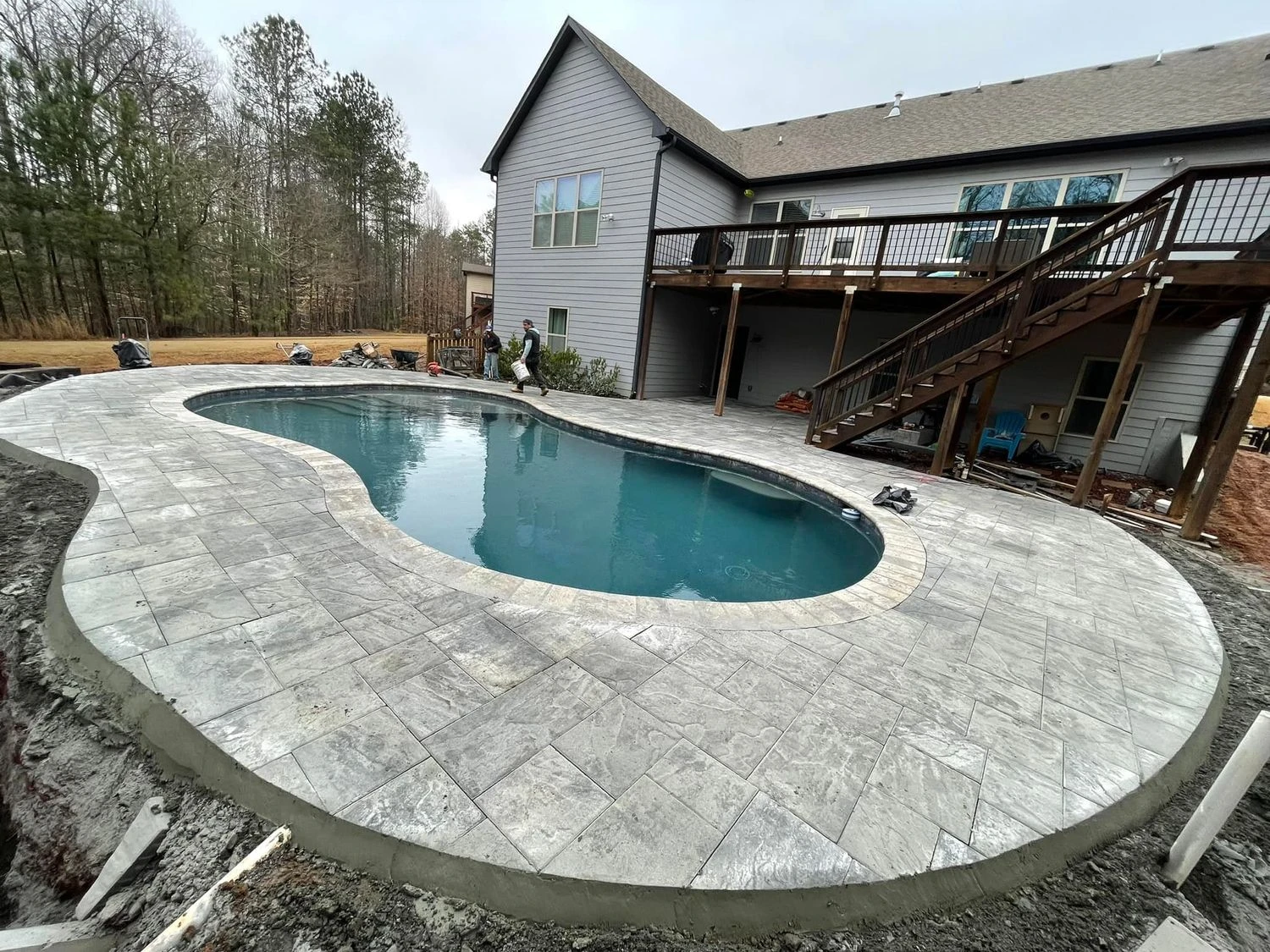 In-progress pool construction with travertine deck in Milton GA