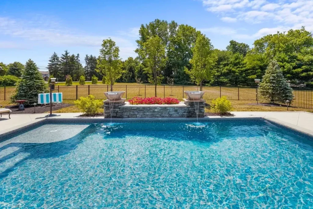 Newly built swimming pool with travertine deck - Smyrna, GA pool builder | Viral Spark Marketing