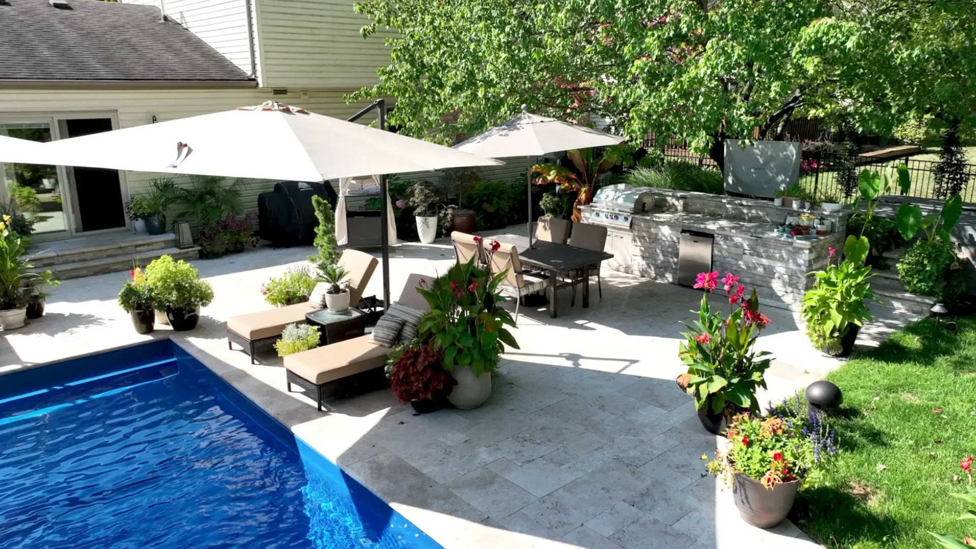 Alpharetta pool patio with market umbrellas and outdoor kitchen