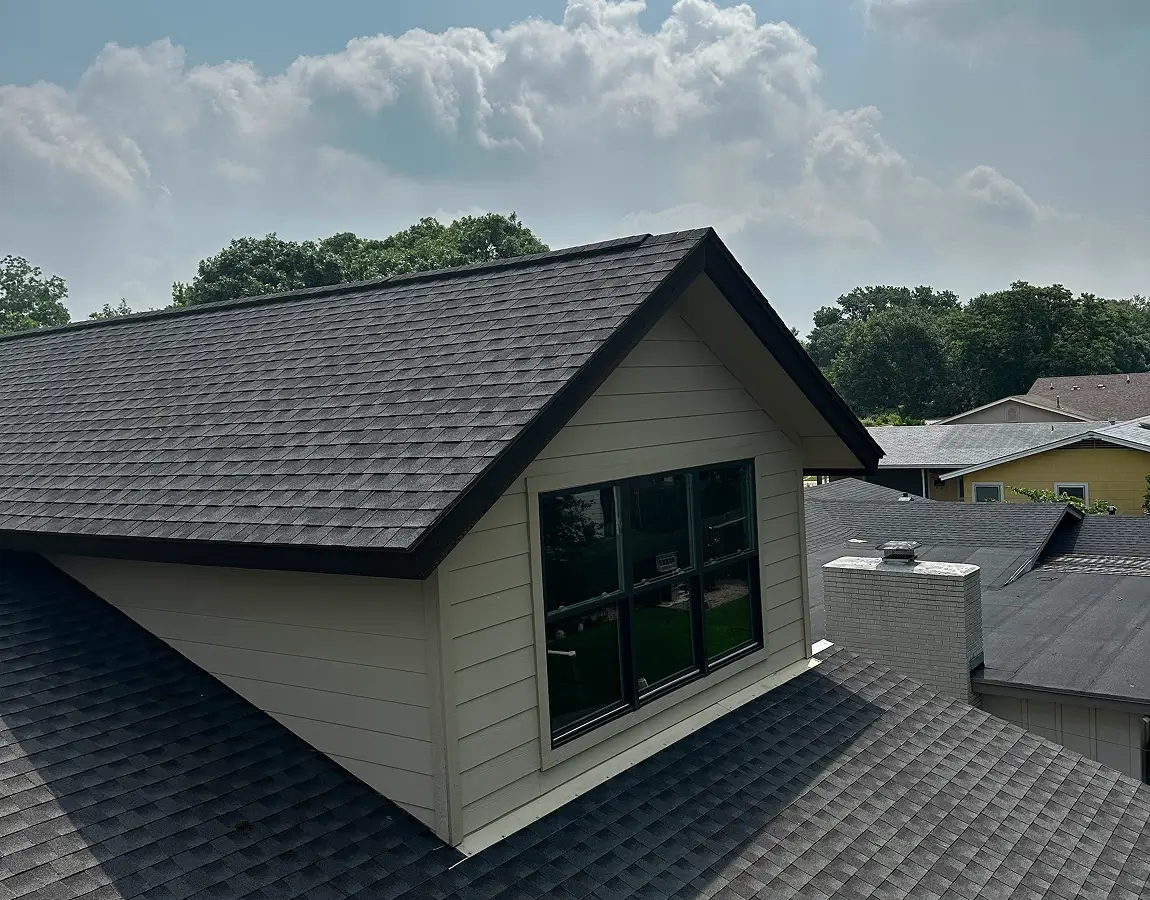 Roofing crew installing shingles at sunset in Alpharetta