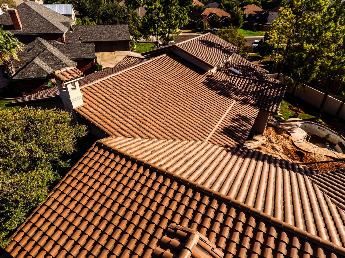 Aerial sunset shot of a luxury North Atlanta home with a finished roof
