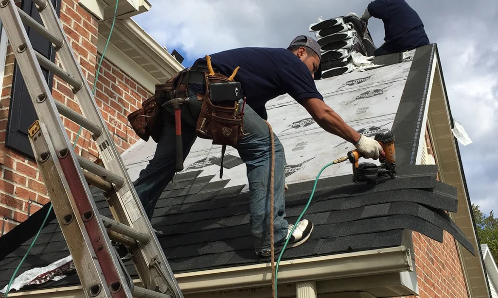 Sunset golden-hour roofing crew laying shingles over ABC underlayment with ladder and dramatic sky - Duluth, GA roofing contractor | Viral Spark Marketing