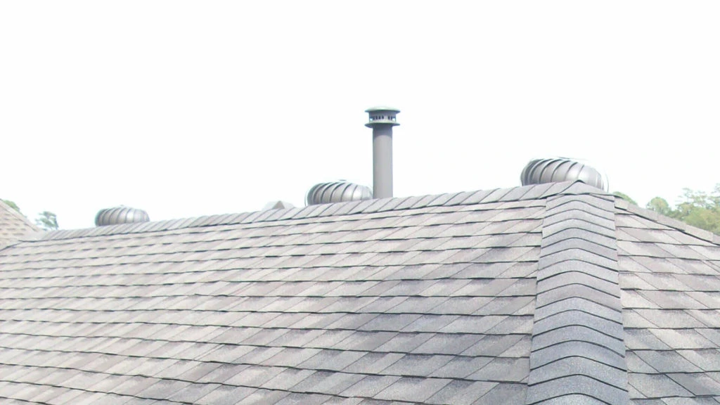 Roofer measuring shingles for replacement in Marietta GA