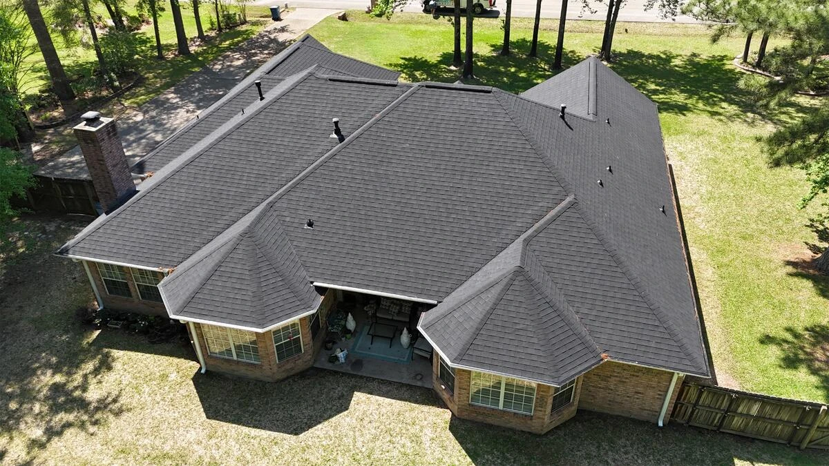 Roswell roofer crew finishing ridge cap on a Holcomb Bridge corridor home