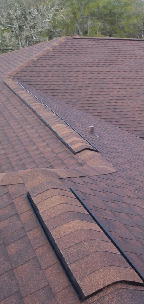 Suwanee roofing crew installing new architectural shingles on residential roof